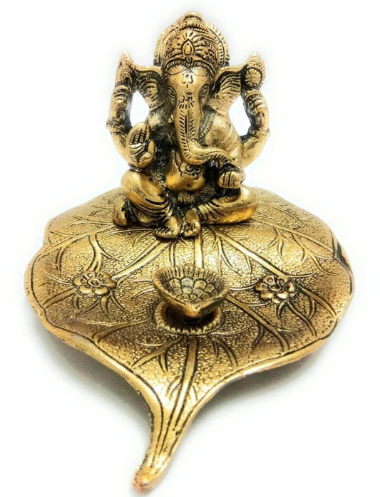 Metal Ganesha Sitting on Leaf Patta with Diya